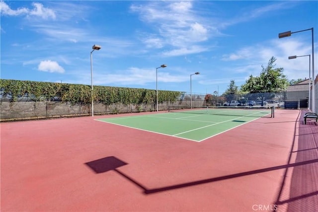 view of tennis court featuring basketball court