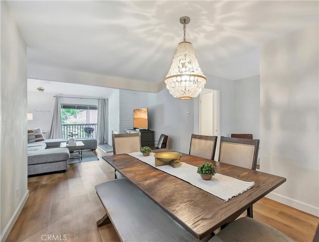 dining room featuring hardwood / wood-style flooring and an inviting chandelier