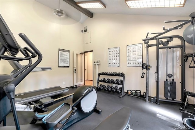 exercise room with ceiling fan and high vaulted ceiling