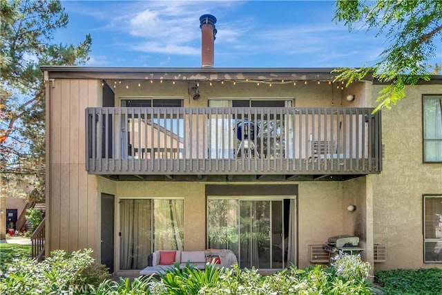 back of property with a balcony