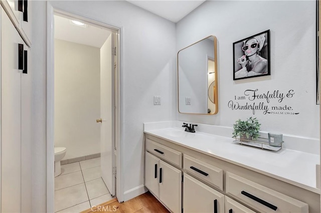 bathroom featuring tile patterned flooring, vanity, and toilet