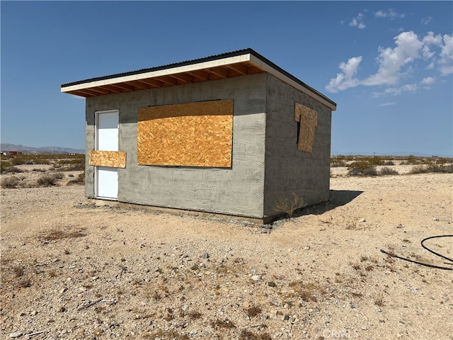 view of home's exterior with an outbuilding