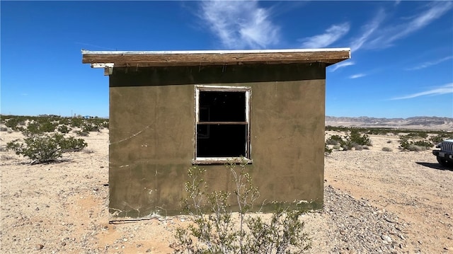 view of property exterior with a shed