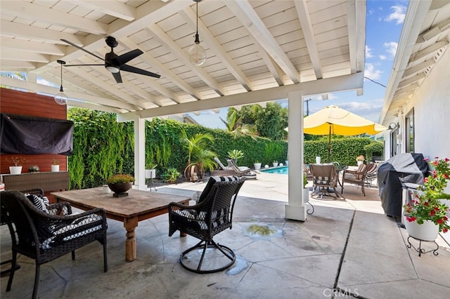 view of patio featuring a fenced in pool, grilling area, and ceiling fan