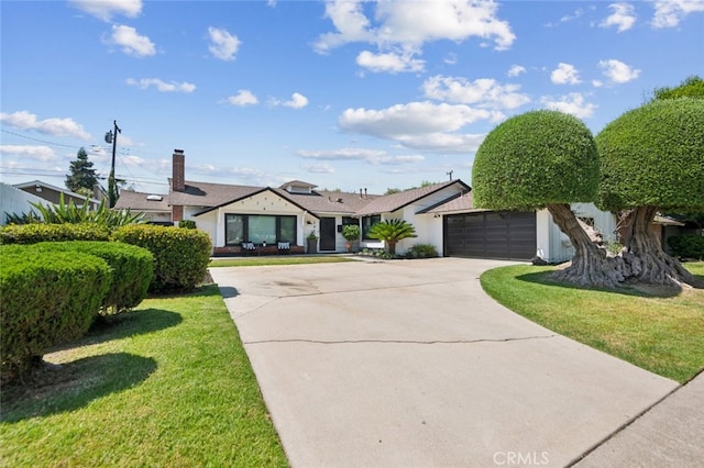 single story home featuring a garage and a front lawn