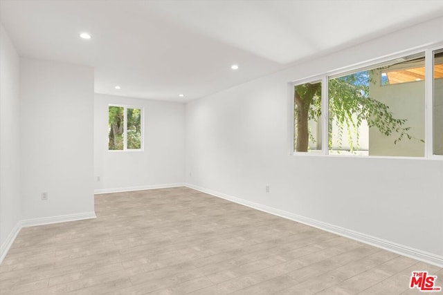 spare room featuring light hardwood / wood-style floors