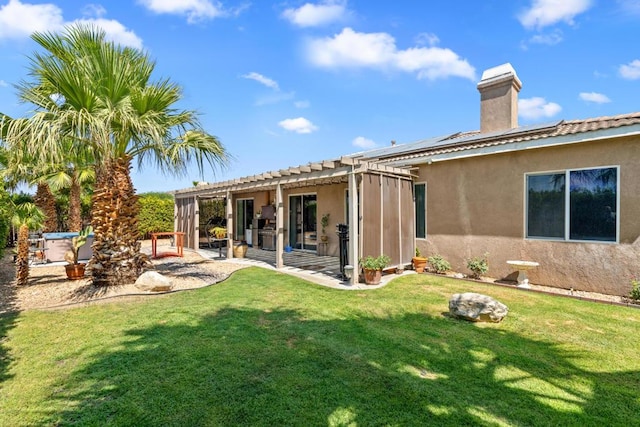 back of property featuring a lawn, a patio area, and a pergola