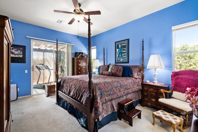 carpeted bedroom with ceiling fan and multiple windows