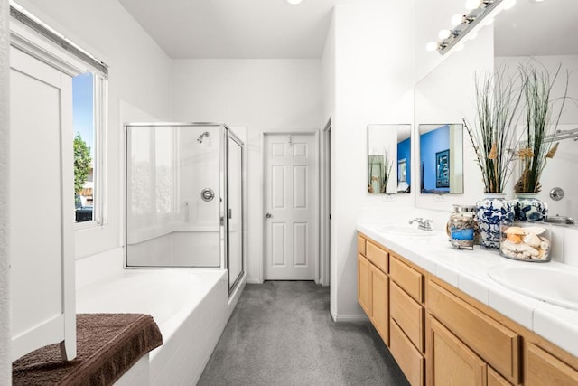 bathroom featuring vanity and shower with separate bathtub