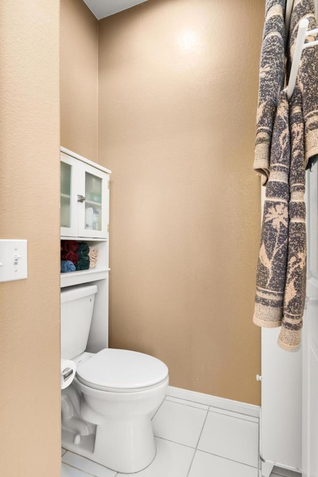 bathroom featuring tile patterned floors and toilet