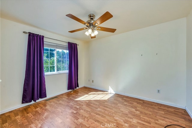 spare room with light hardwood / wood-style floors and ceiling fan