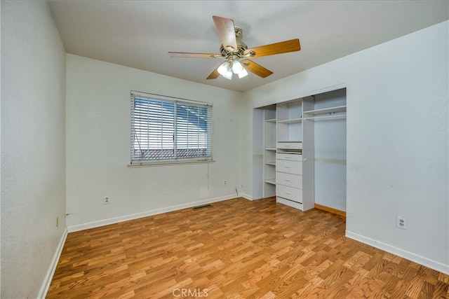 unfurnished bedroom with light wood-type flooring, ceiling fan, and a closet