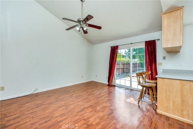 interior space with ceiling fan, wood-type flooring, and high vaulted ceiling