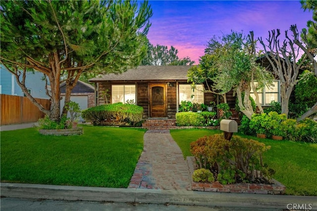 view of front of property with a yard