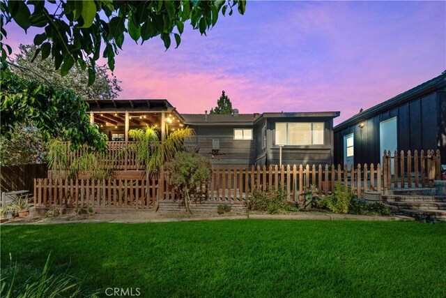 back house at dusk with a yard