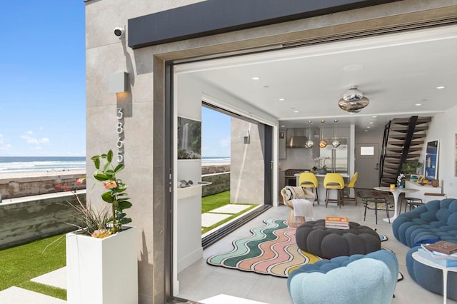 living room with a water view and a view of the beach