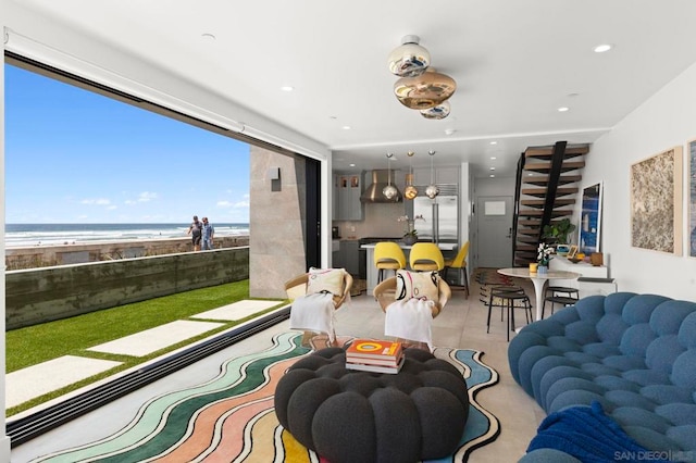 living room with a view of the beach and a water view