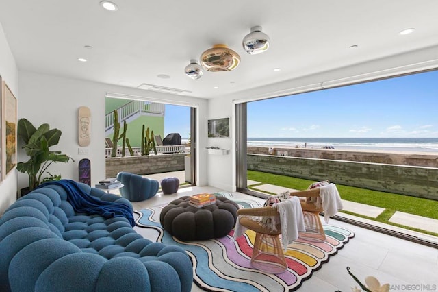 living room with tile patterned floors and a water view