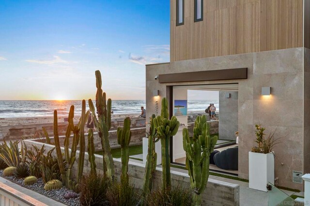 exterior space featuring a water view and a view of the beach