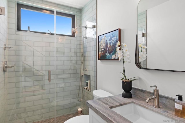 bathroom with vanity, toilet, and an enclosed shower