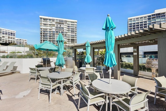 view of patio with a pergola and area for grilling