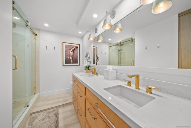 bathroom with vanity, wood-type flooring, and walk in shower