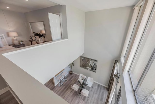 stairway with hardwood / wood-style floors