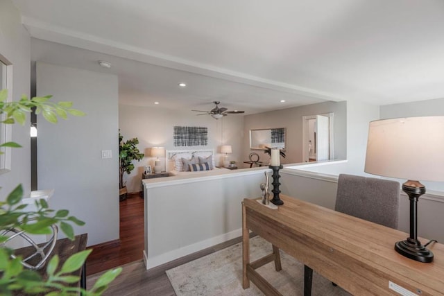 interior space with ceiling fan and dark hardwood / wood-style flooring