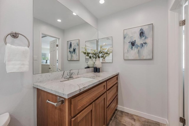 bathroom featuring vanity and toilet