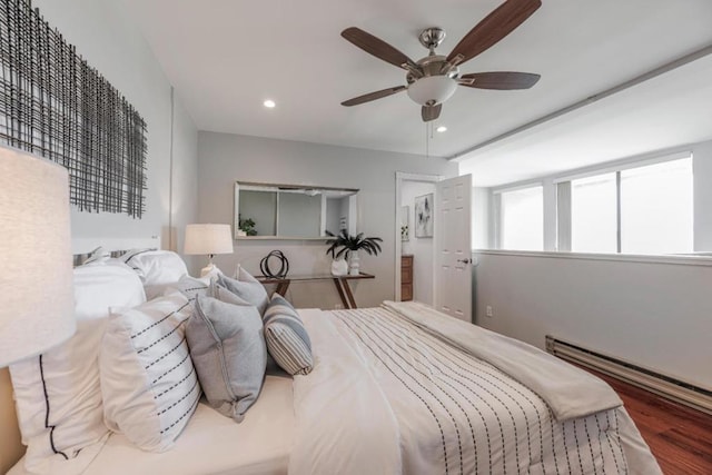 bedroom with wood-type flooring, ceiling fan, and baseboard heating