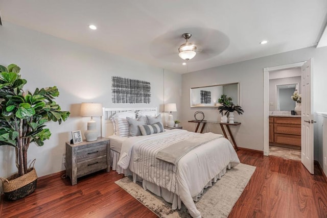 bedroom featuring dark wood-type flooring, connected bathroom, and ceiling fan