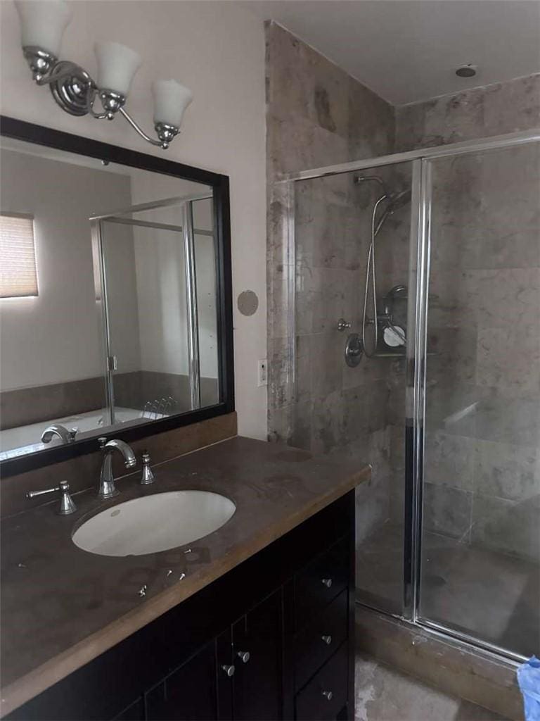 bathroom with a stall shower and vanity