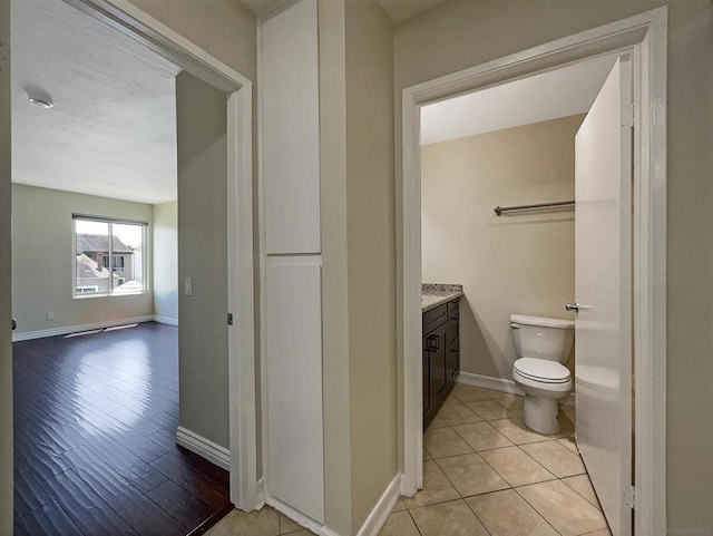 bathroom with vanity, wood-type flooring, and toilet