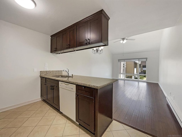 kitchen featuring light wood-type flooring, dark brown cabinetry, white dishwasher, sink, and lofted ceiling