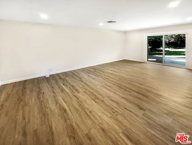 empty room with hardwood / wood-style flooring