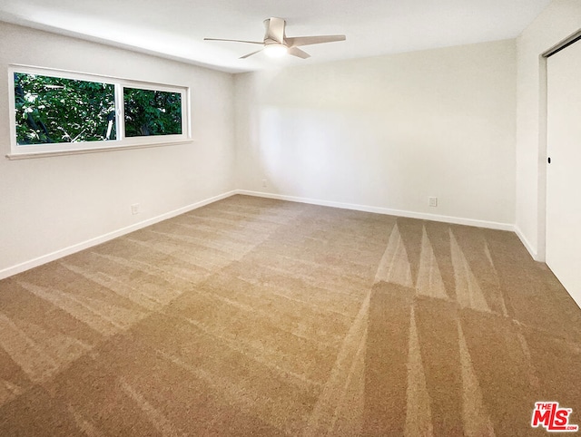 spare room with ceiling fan and carpet floors