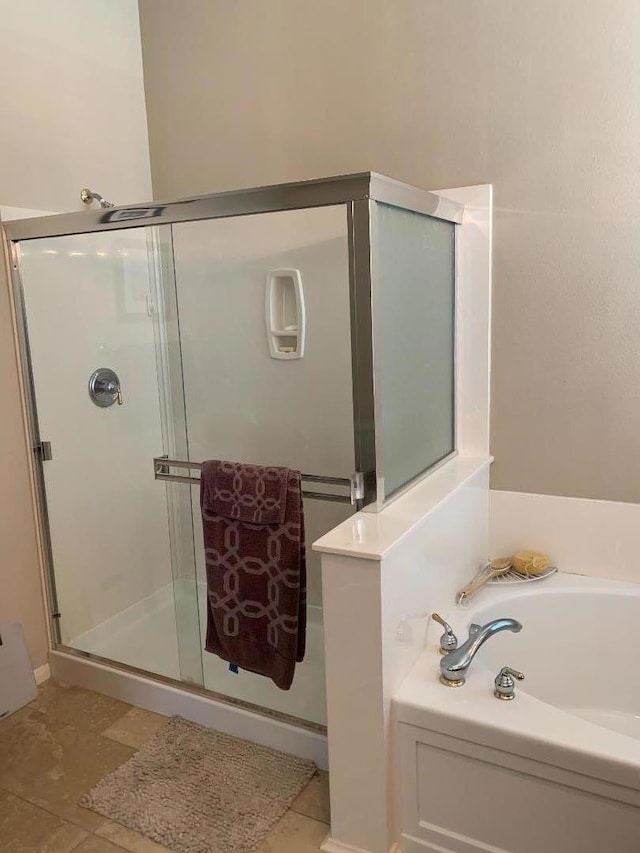 bathroom featuring independent shower and bath and tile patterned floors