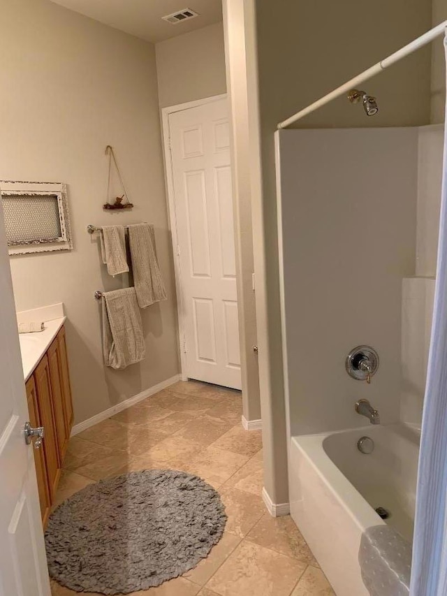 bathroom featuring vanity,  shower combination, and tile patterned flooring