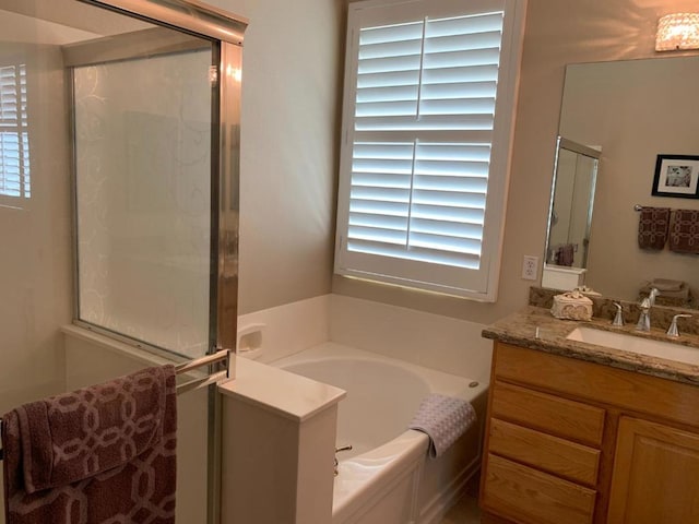 bathroom featuring independent shower and bath and vanity