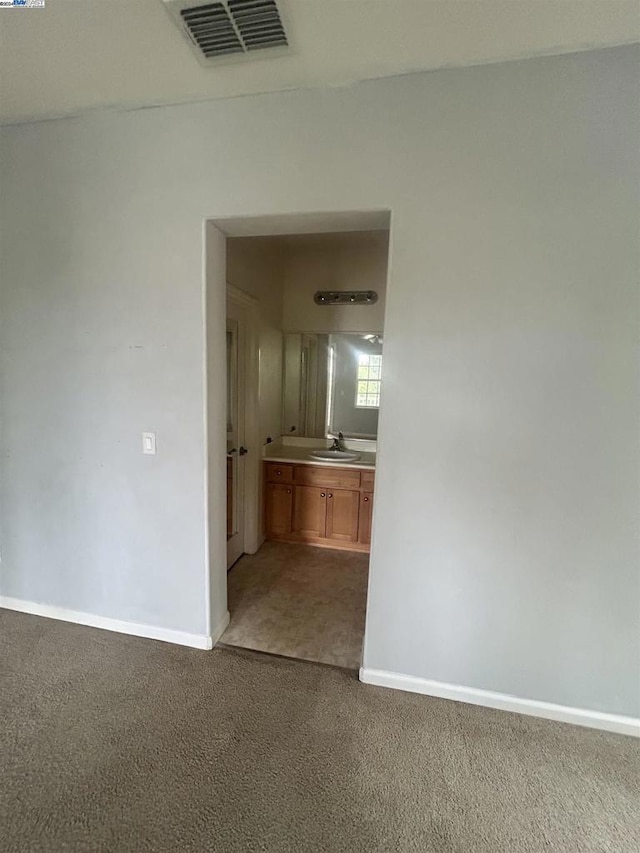 corridor featuring carpet flooring and sink