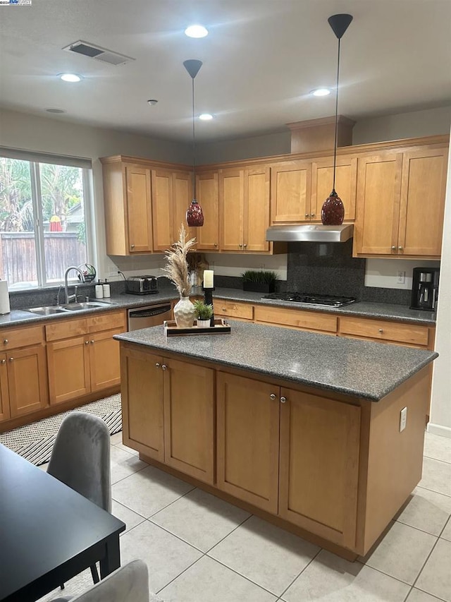 kitchen with light tile patterned flooring, decorative light fixtures, stainless steel appliances, and sink