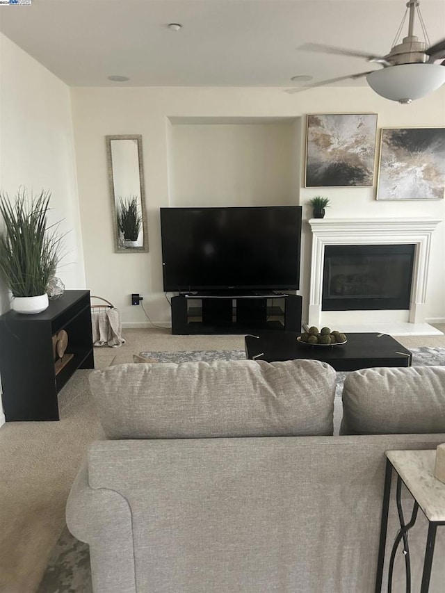 living room featuring carpet flooring and ceiling fan