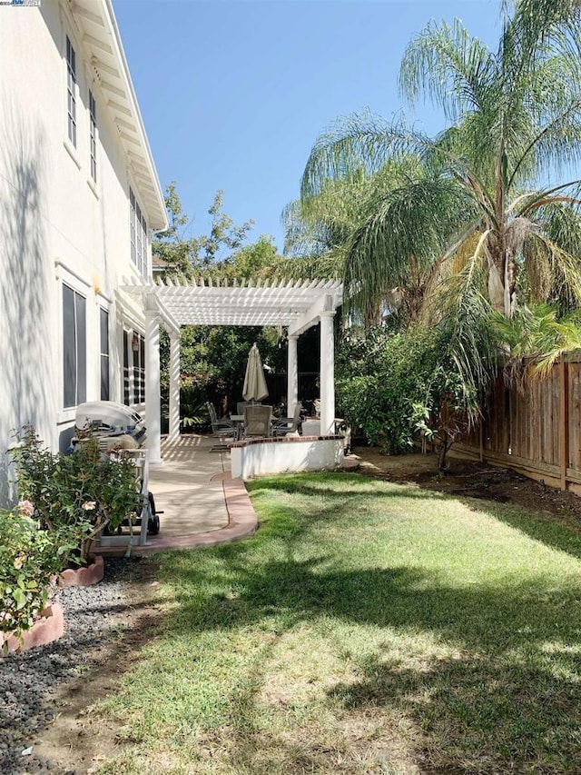 view of yard with a pergola and a patio