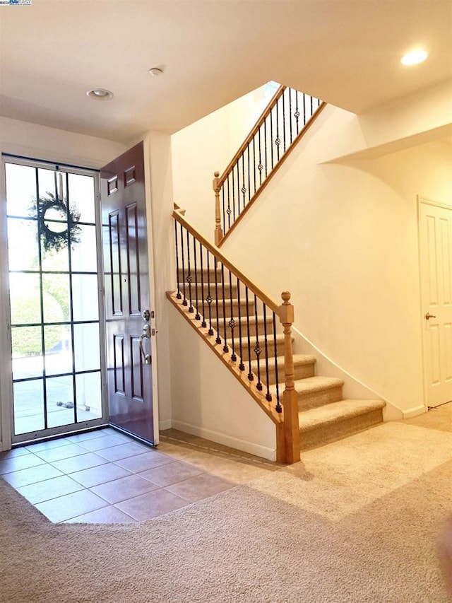 foyer entrance with carpet flooring