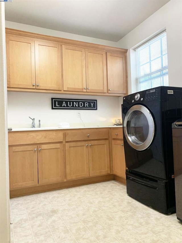 laundry room with cabinets and sink