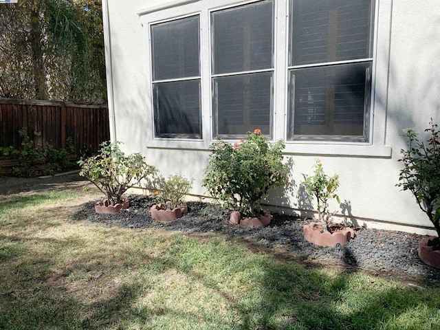 view of side of home with a lawn