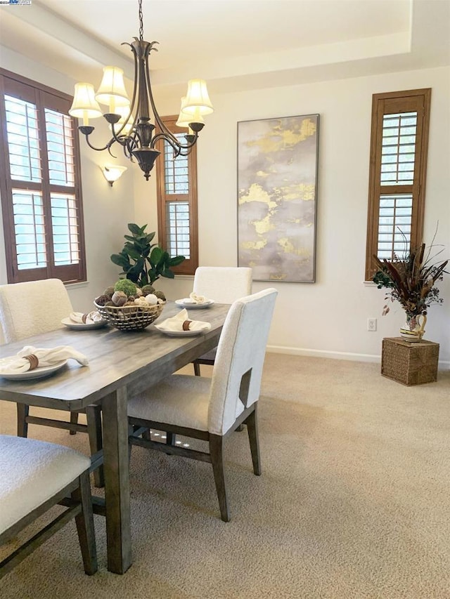 carpeted dining room with a notable chandelier and a wealth of natural light