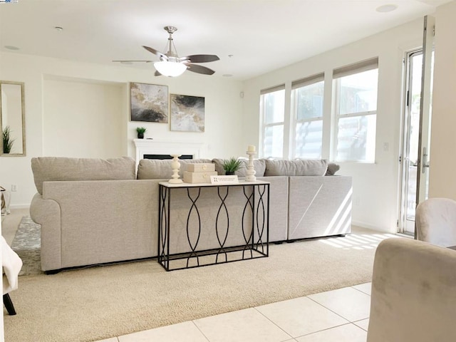 tiled living room with ceiling fan