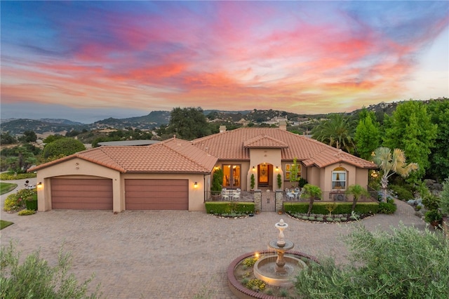 mediterranean / spanish-style home featuring a mountain view and a garage