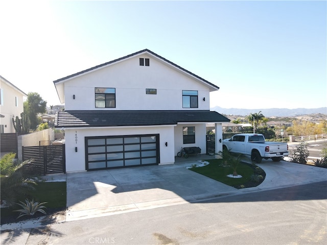 view of front facade with a mountain view and a garage